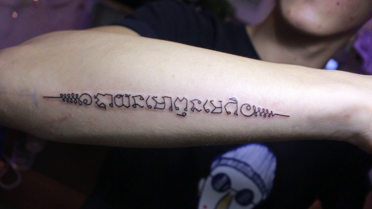Hình xăm dòng chữ bùa Thái ở tay